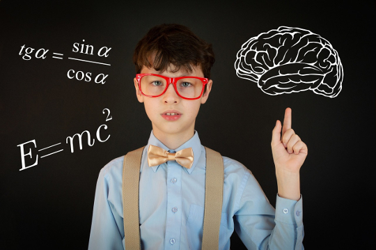 Committing to the Pursuit of Mastery young boy in front of a blackboard