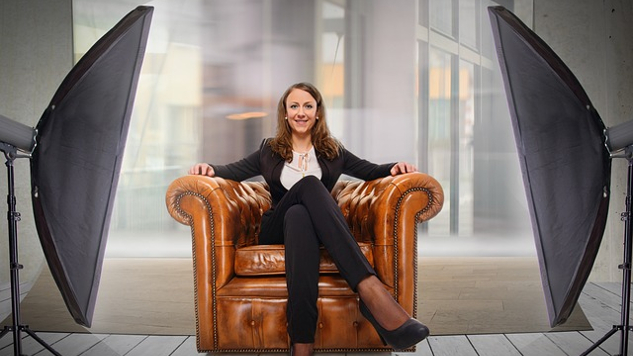 young woman sitting comfortably and confidently in an arm chair