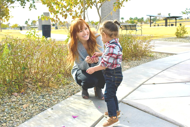 a smilingmother crouching down with her son