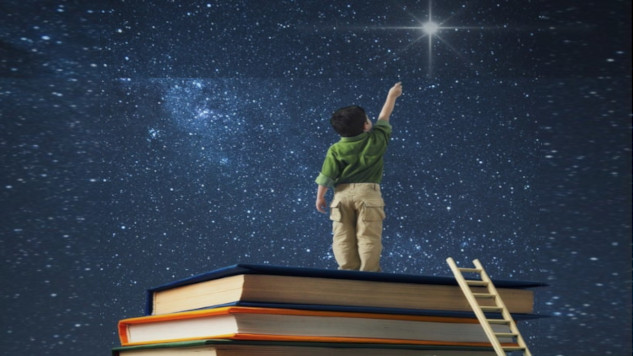 a young boy standing on a stack of books reaching for the North Star