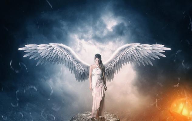 an angel with wings open wide with light radiating all around
