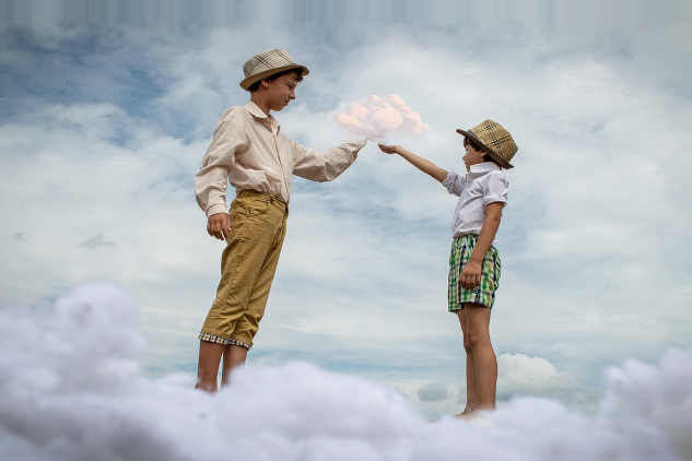 Two boys stretching their fingers to each other similar to the classic Michaelangelo image of God creating humanity. Image by Victoria from Pixabay.&nbsp;