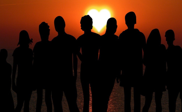 A group of people standing together in the light. Image by Enlightening Images from Pixabay.&nbsp;