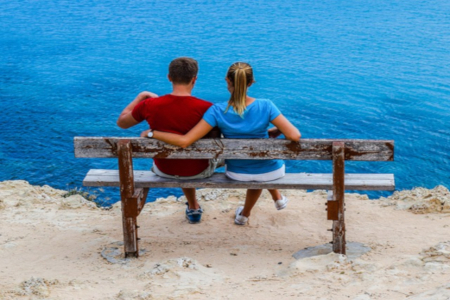 A couple sitting on a bench with the woman's arm around the shoulders of the man.&nbsp;Image by Dimitris Vetsikas from Pixabay.&nbsp;