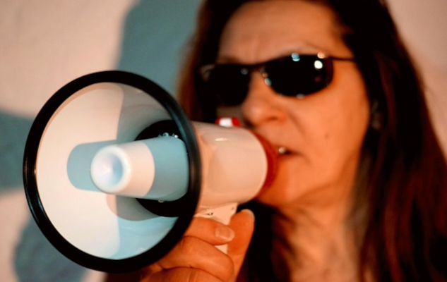 woman speaking through a megaphone. 